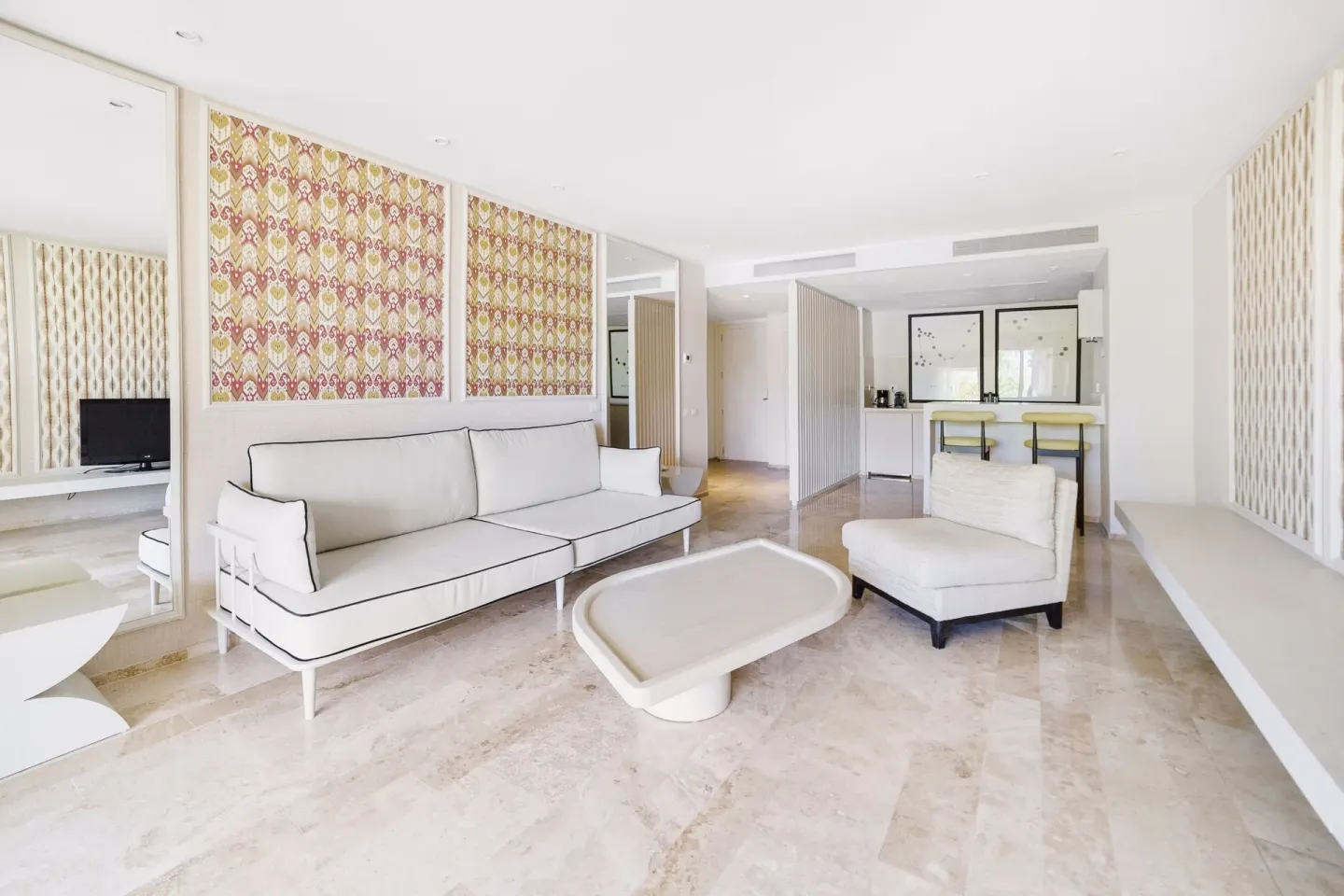 Premium Suite sitting area with sofa, chair, coffee table, and bar counter at Privilege Aluxes Isla Mujeres.