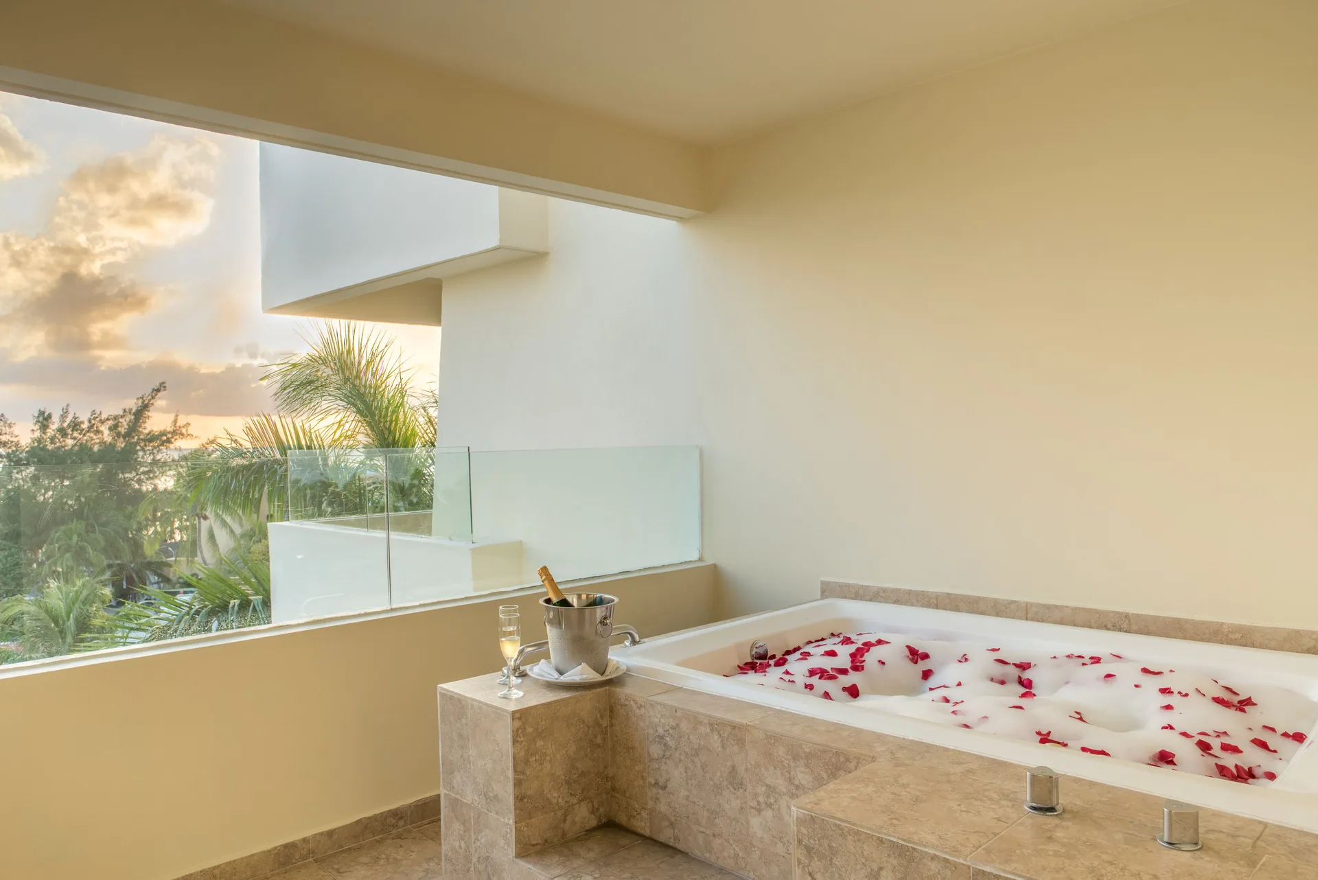 Whirlpool bath with rose petals on the suite terrace at Privilege Aluxes Isla Mujeres.