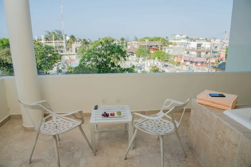 Superior Aluxes balcony seating and whirlpool with town view at Privilege Aluxes Isla Mujeres.