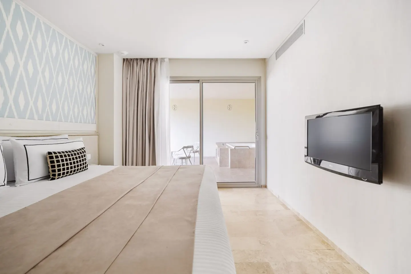Superior Aluxes room with king bed, wall TV, and balcony whirlpool at Privilege Aluxes Isla Mujeres.