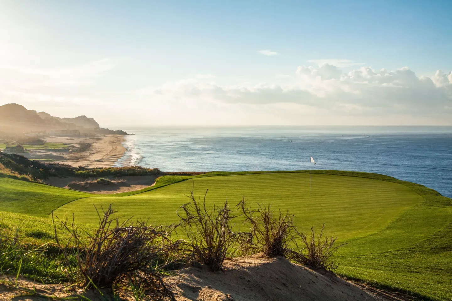 Coastal golf green and beach at sunrise near Pueblo Bonito Los Cabos Blanco.