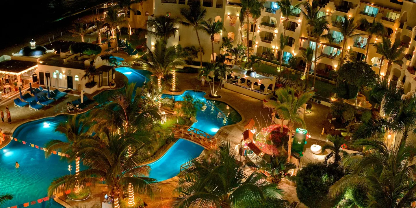 Illuminated pools and palms seen from above at Pueblo Bonito Los Cabos Blanco.
