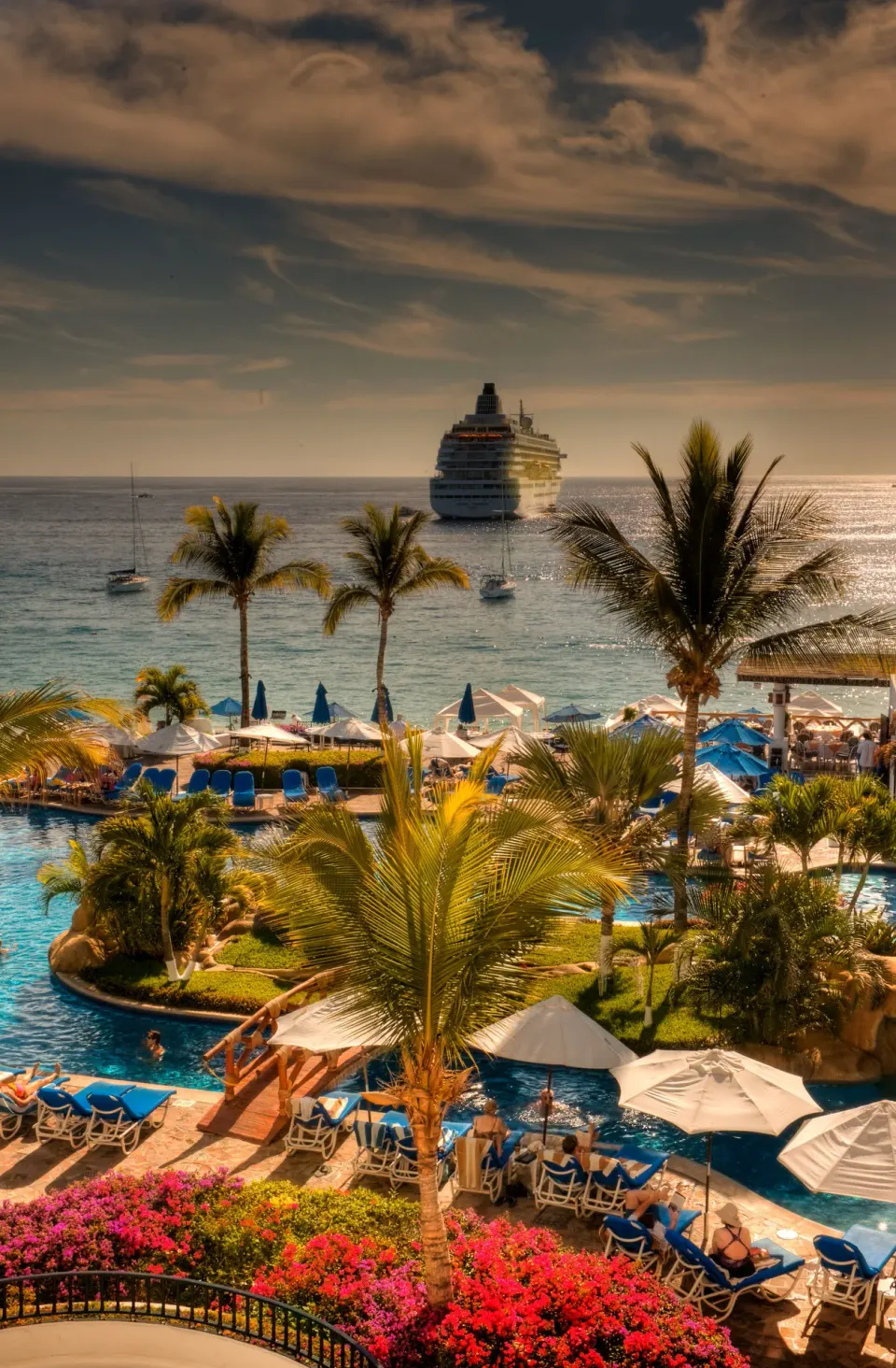 Pool deck, palms, and cruise ship offshore at Pueblo Bonito Los Cabos Blanco.