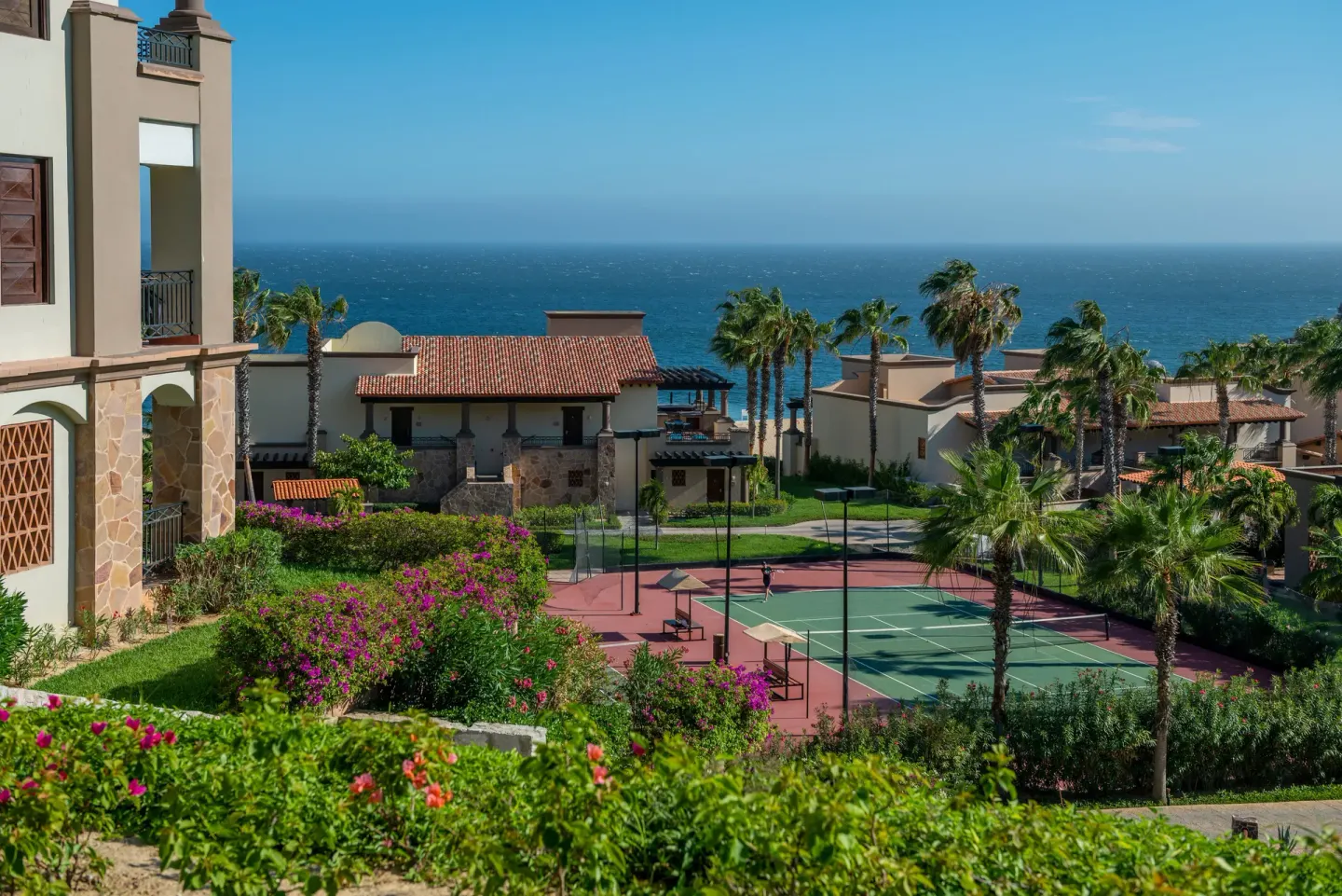 Resort grounds with tennis courts and ocean view at Pueblo Bonito Los Cabos Blanco.