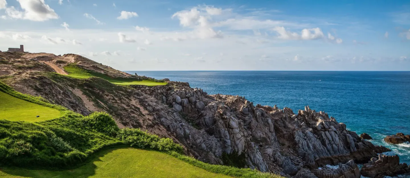 Rocky ocean cliffs and golf fairways near Pueblo Bonito Los Cabos Blanco.