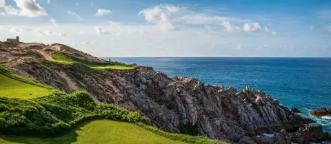 Rocky ocean cliffs and golf fairways near Pueblo Bonito Los Cabos Blanco.