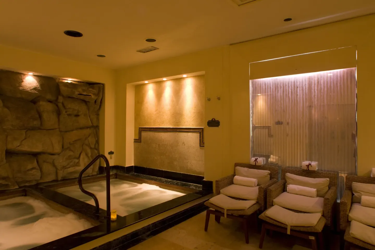 Spa hydrotherapy room with whirlpool and lounge chairs at Pueblo Bonito Los Cabos Blanco.
