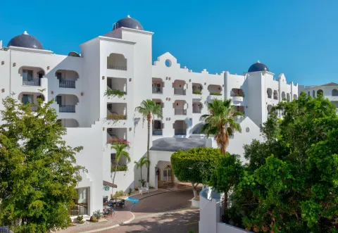 White resort building with domed towers and palms at Pueblo Bonito Los Cabos Blanco.