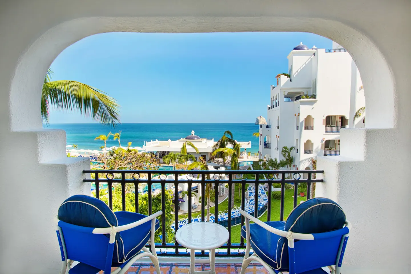 Junior Suite Ocean View balcony with chairs overlooking the sea at Pueblo Bonito Los Cabos Blanco.