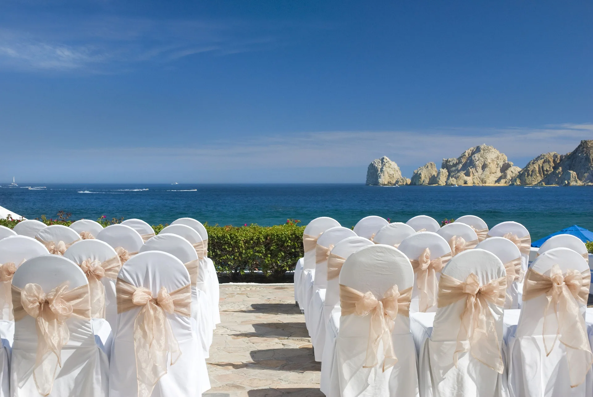 Rows of white ceremony chairs face the ocean at Pueblo Bonito Los Cabos Blanco.