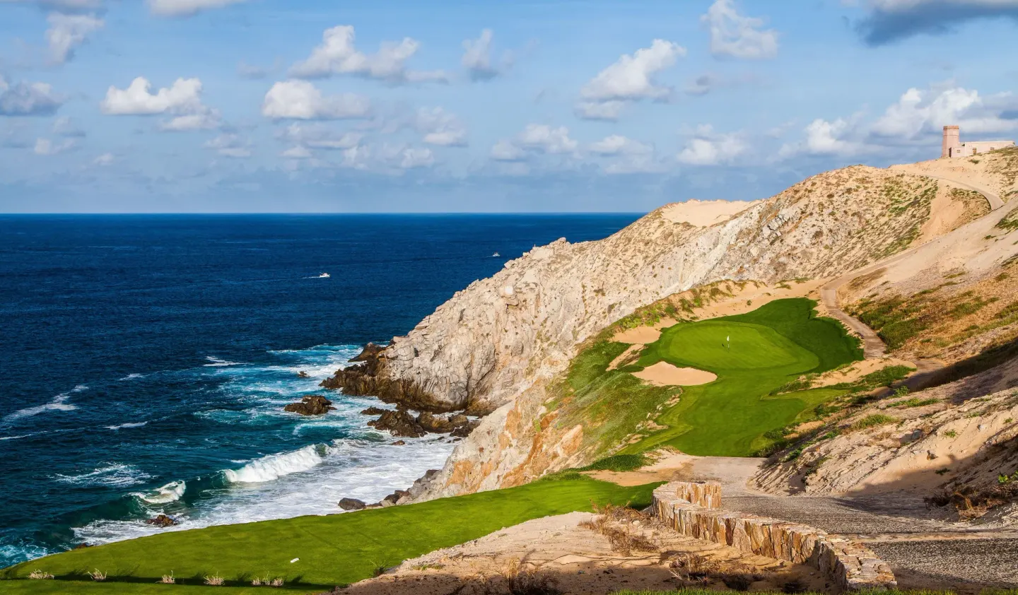 Cliffside golf holes above ocean waves at Pueblo Bonito Montecristo Luxury Villas.