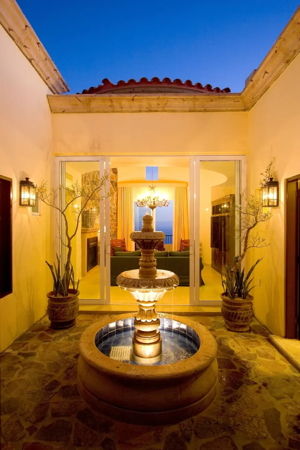 Illuminated courtyard fountain outside a villa at Pueblo Bonito Montecristo Luxury Villas.