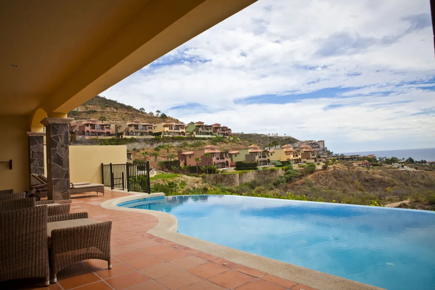 Infinity-edge pool overlooking hillside villas at Pueblo Bonito Montecristo Luxury Villas.
