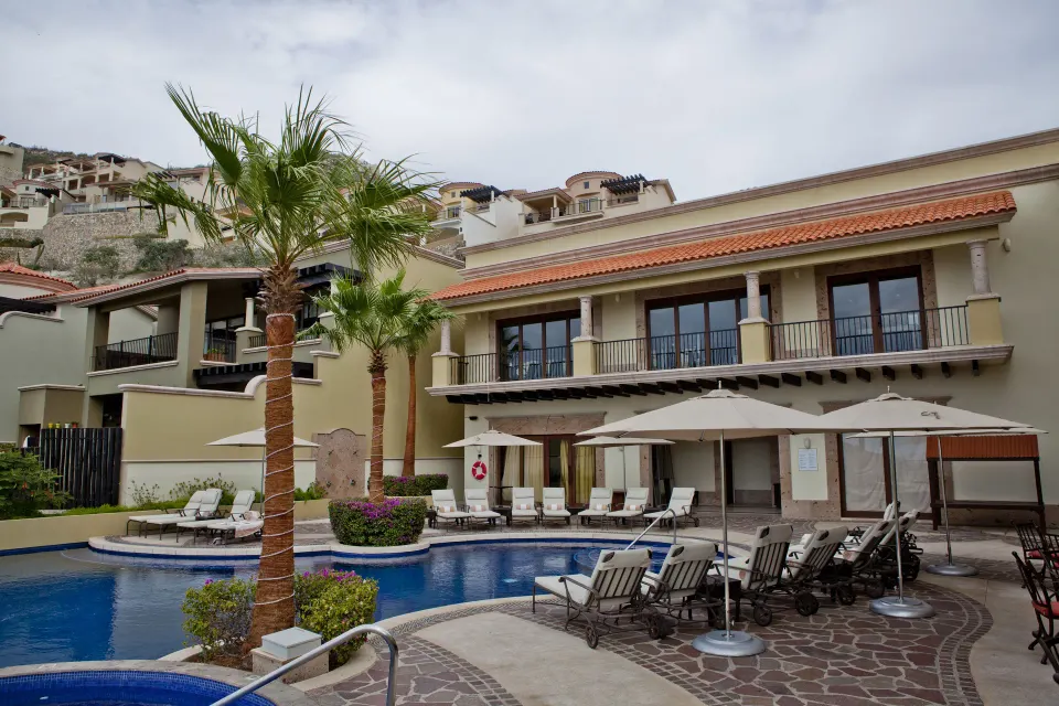 Pool courtyard with loungers and villa building at Pueblo Bonito Montecristo Luxury Villas.