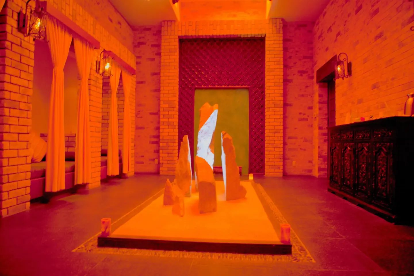 Warmly lit spa room with sculptural stones at Pueblo Bonito Montecristo Luxury Villas.