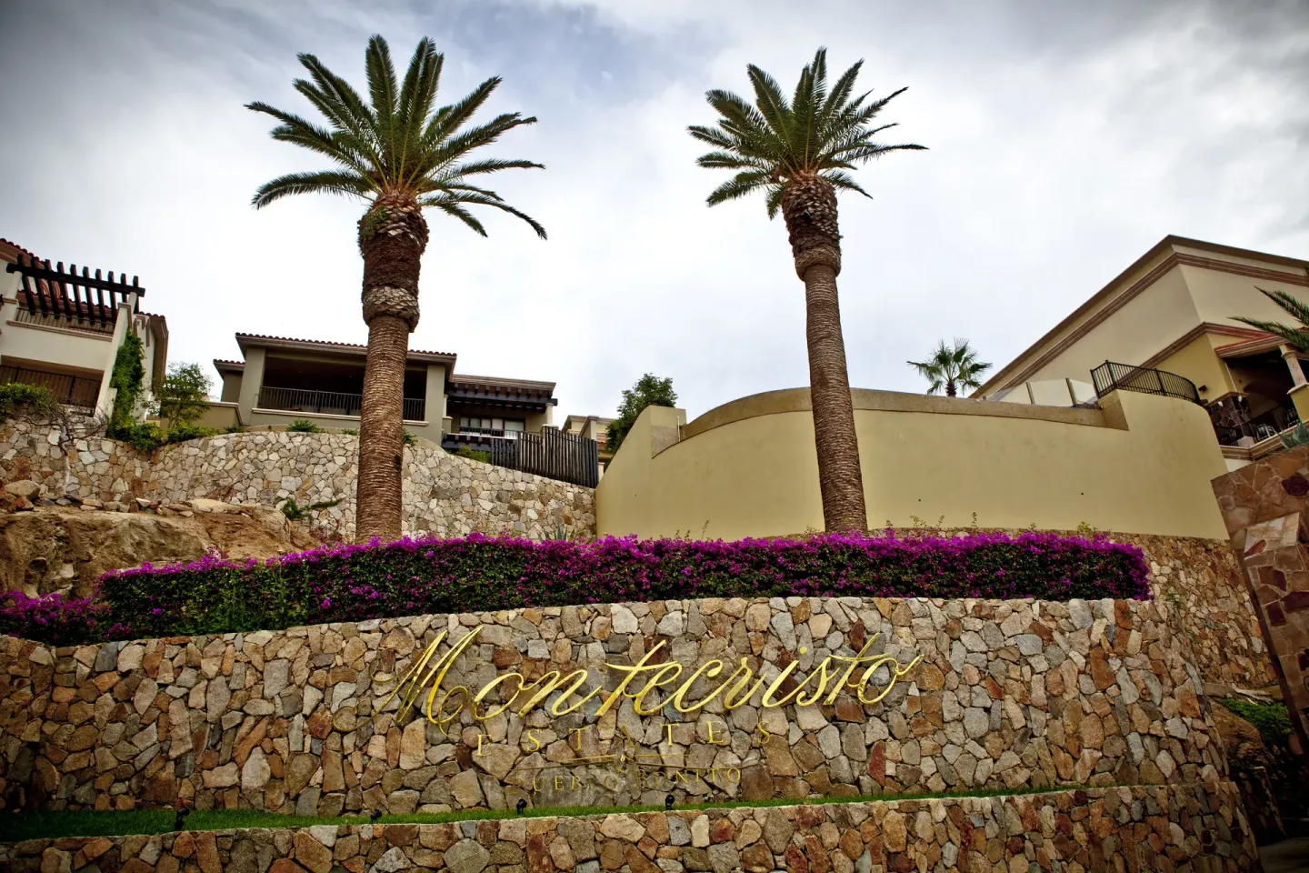 Stone Montecristo sign with palms at Pueblo Bonito Montecristo Luxury Villas.