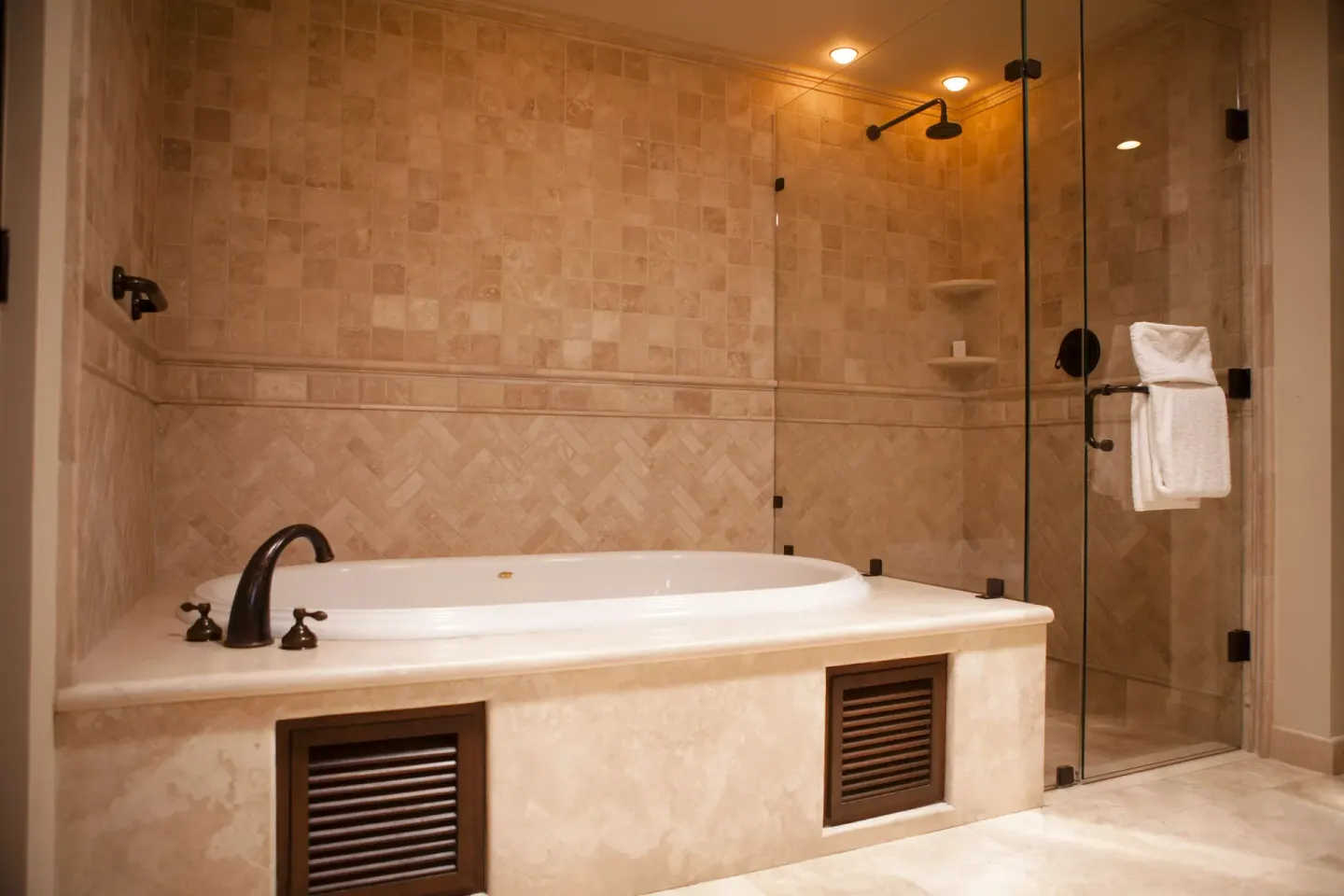 Stone-tiled bathroom with soaking tub and glass shower at Pueblo Bonito Montecristo Luxury Villas.