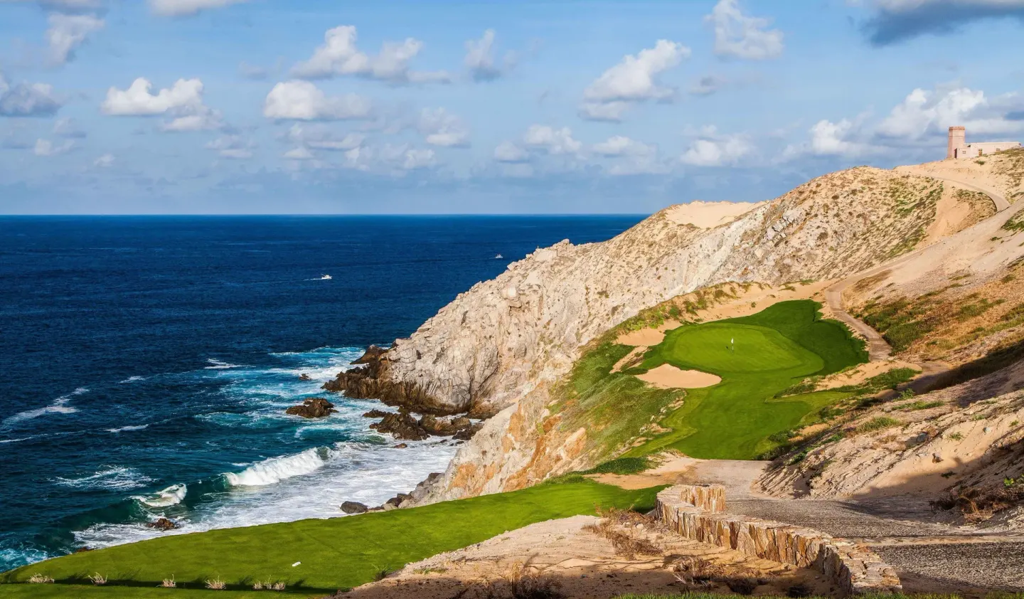Clifftop golf green beside the ocean at Pueblo Bonito Pacifica Golf & Spa Resort.
