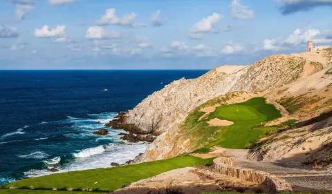 Clifftop golf green beside the ocean at Pueblo Bonito Pacifica Golf & Spa Resort.