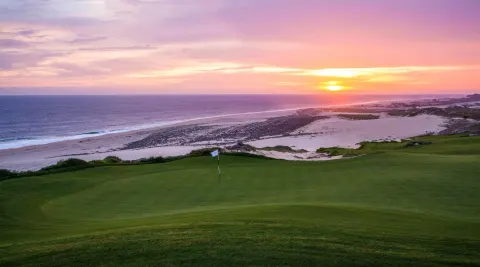 Golf green and beach at sunset at Pueblo Bonito Pacifica Golf & Spa Resort.