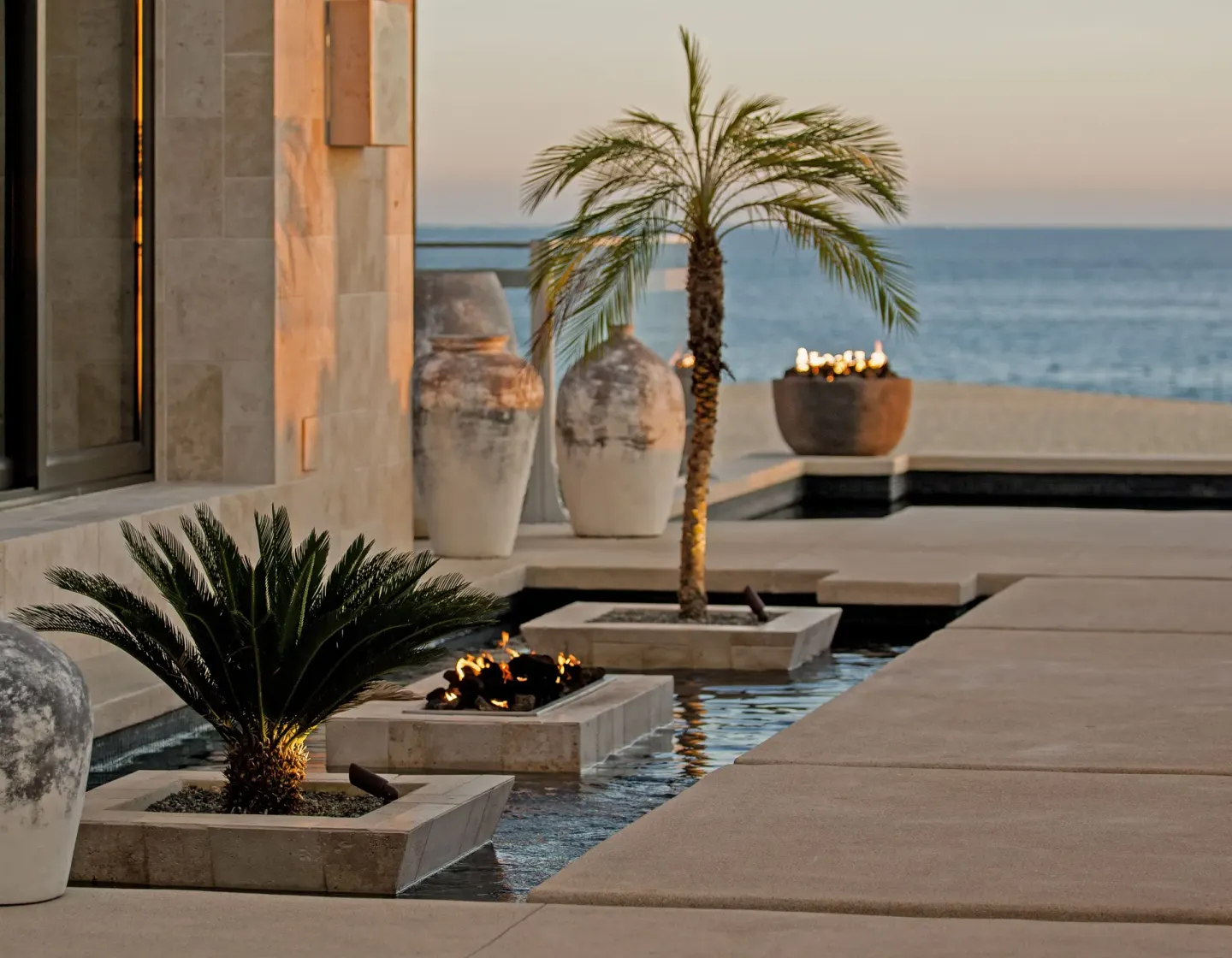 Reflecting pool with palms and ocean view at Pueblo Bonito Pacifica Golf & Spa Resort.