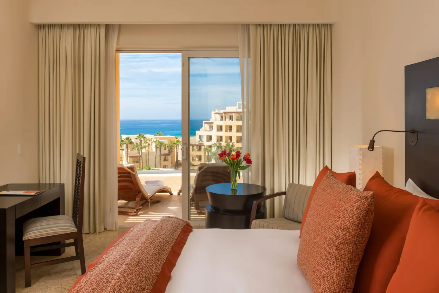 Deluxe Oceanview Room with king bed, sitting area, and balcony at Pueblo Bonito Pacifica Golf & Spa Resort.