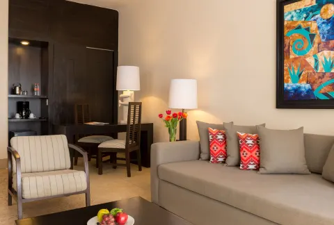 Oceanview Suite sitting area with sofa and desk at Pueblo Bonito Pacifica Golf & Spa Resort.