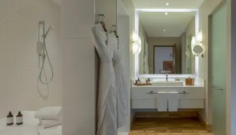 Bathroom with robes in a Towers Private Pool Suite at Pueblo Bonito Pacifica Golf & Spa Resort.