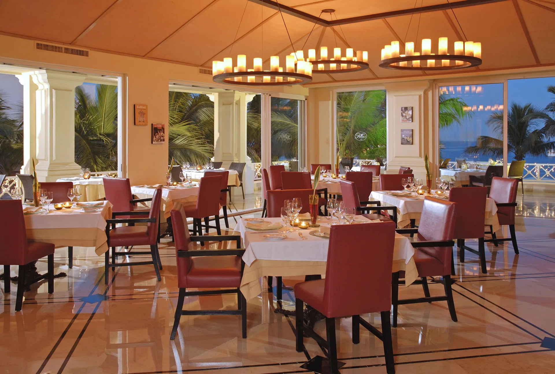 Formal restaurant dining room with red chairs at Pueblo Bonito Rose Resort and Spa.