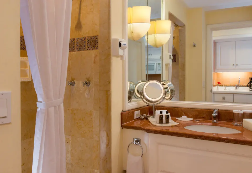 Junior Suite bathroom with vanity and tiled shower at Pueblo Bonito Rose Resort and Spa.