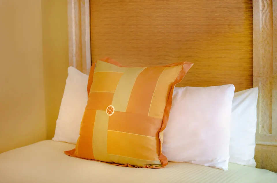 Junior Suite bed pillows and woven headboard at Pueblo Bonito Rose Resort and Spa.