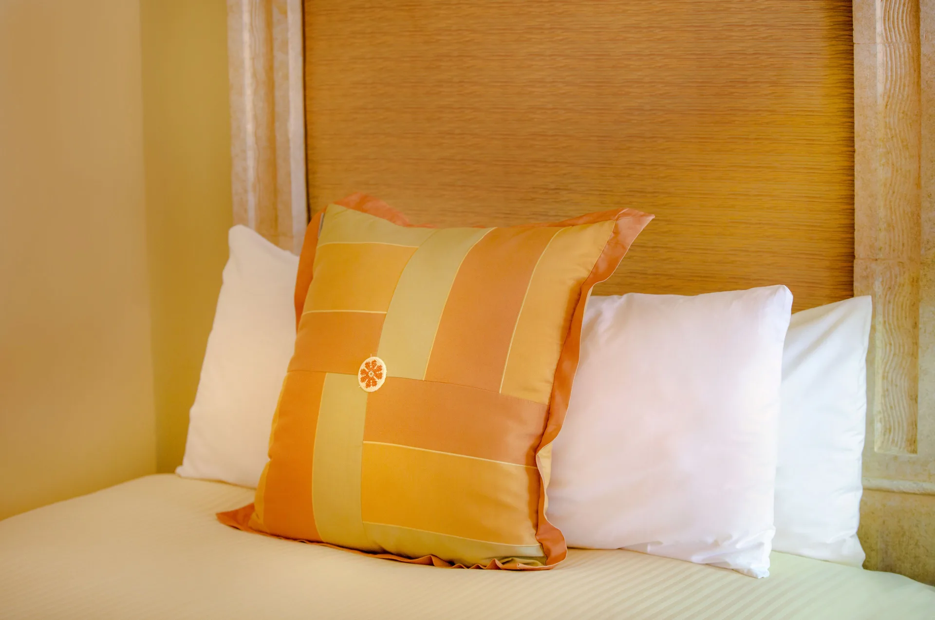 Junior Suite bed pillows and woven headboard at Pueblo Bonito Rose Resort and Spa.