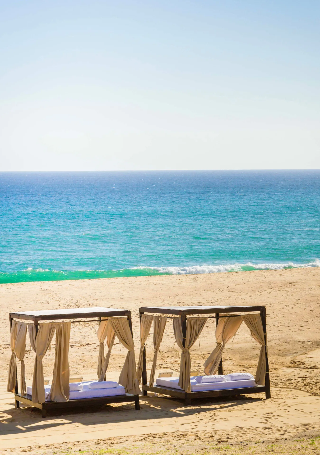 Beach cabanas facing the ocean at Pueblo Bonito Sunset Beach Golf & Spa Resort.