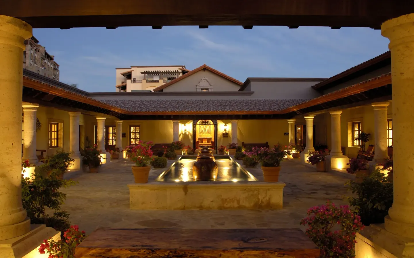 Evening courtyard with fountain and colonnades at Pueblo Bonito Sunset Beach Golf & Spa Resort.