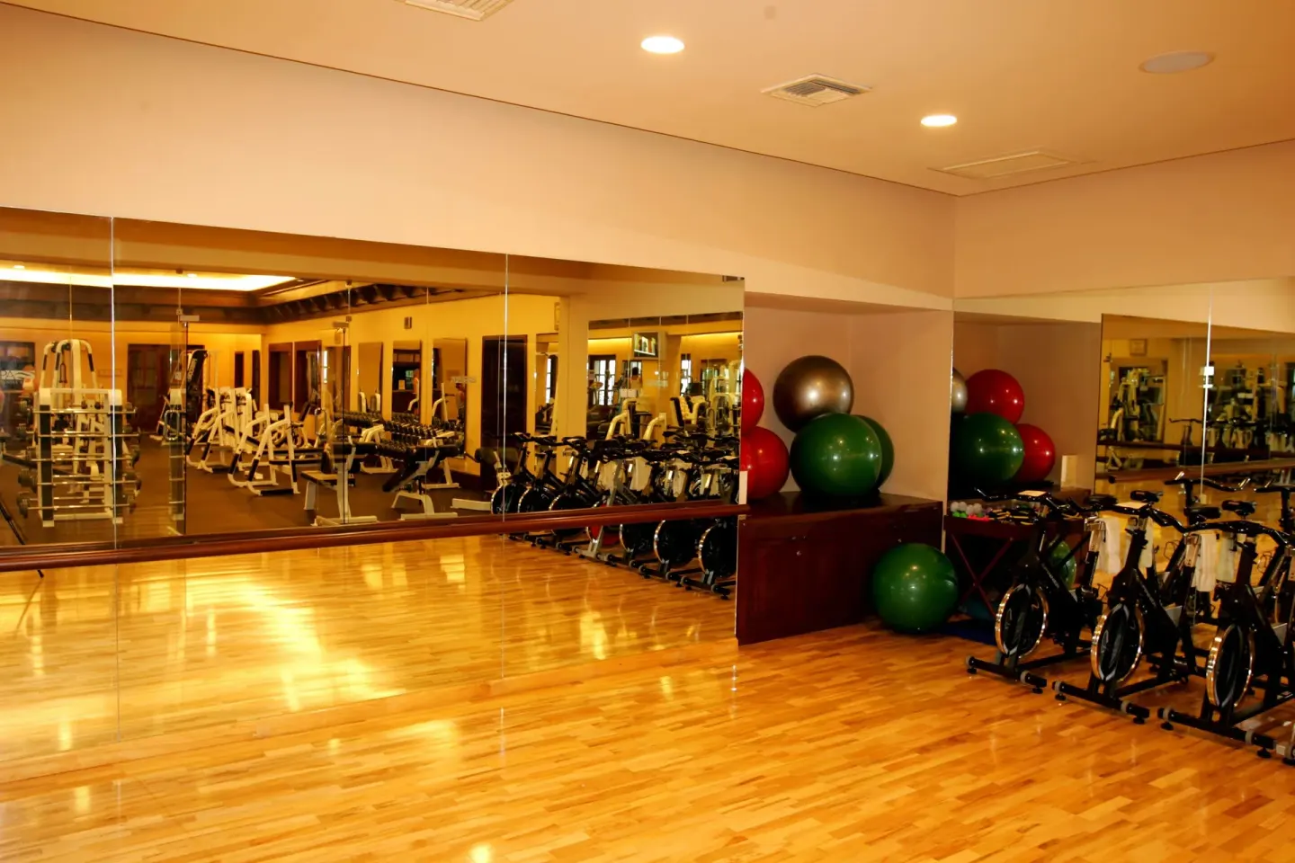 Fitness studio with mirrors, bikes, weights, and exercise balls at Pueblo Bonito Sunset Beach Golf & Spa Resort.