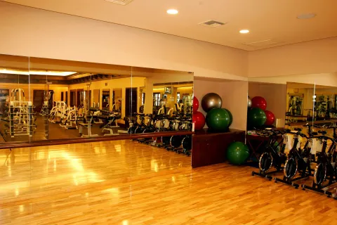 Fitness studio with mirrors, bikes, weights, and exercise balls at Pueblo Bonito Sunset Beach Golf & Spa Resort.