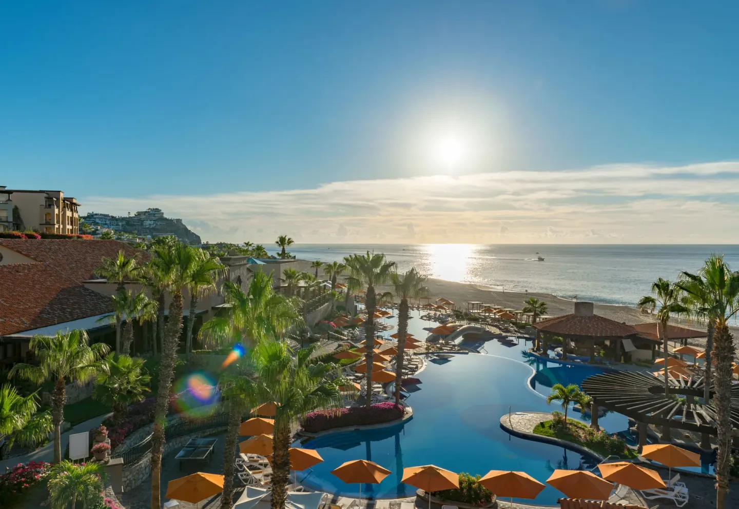 Oceanfront pool with palm trees at Pueblo Bonito Sunset Beach Golf & Spa Resort.