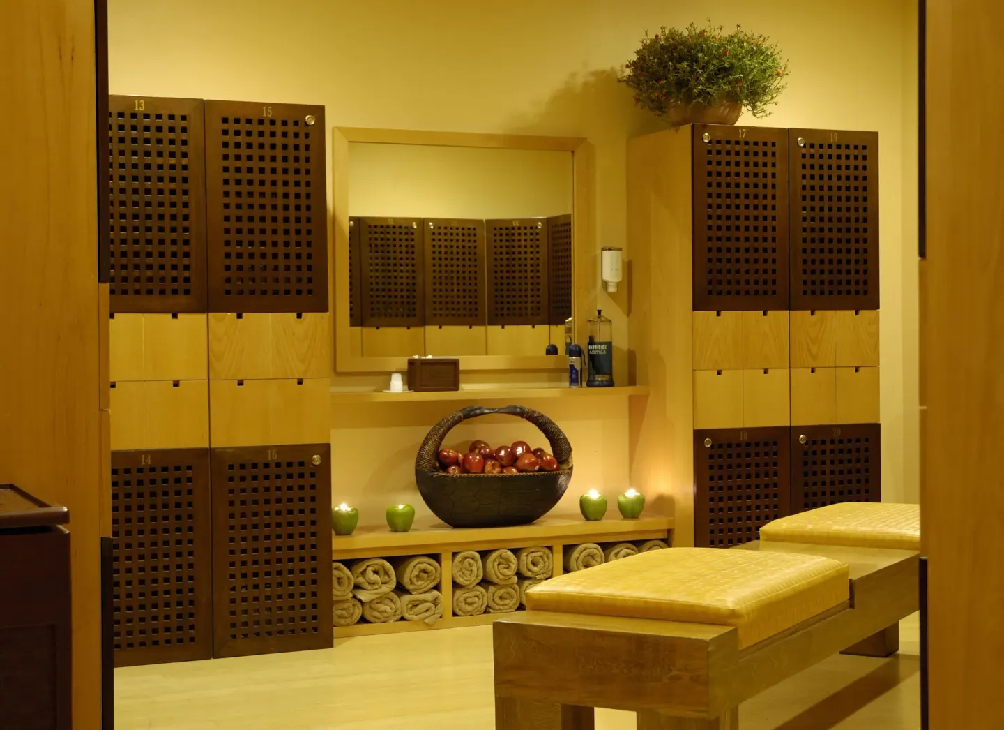 Spa locker room with benches, towels, and wood lockers at Pueblo Bonito Sunset Beach Golf & Spa Resort.