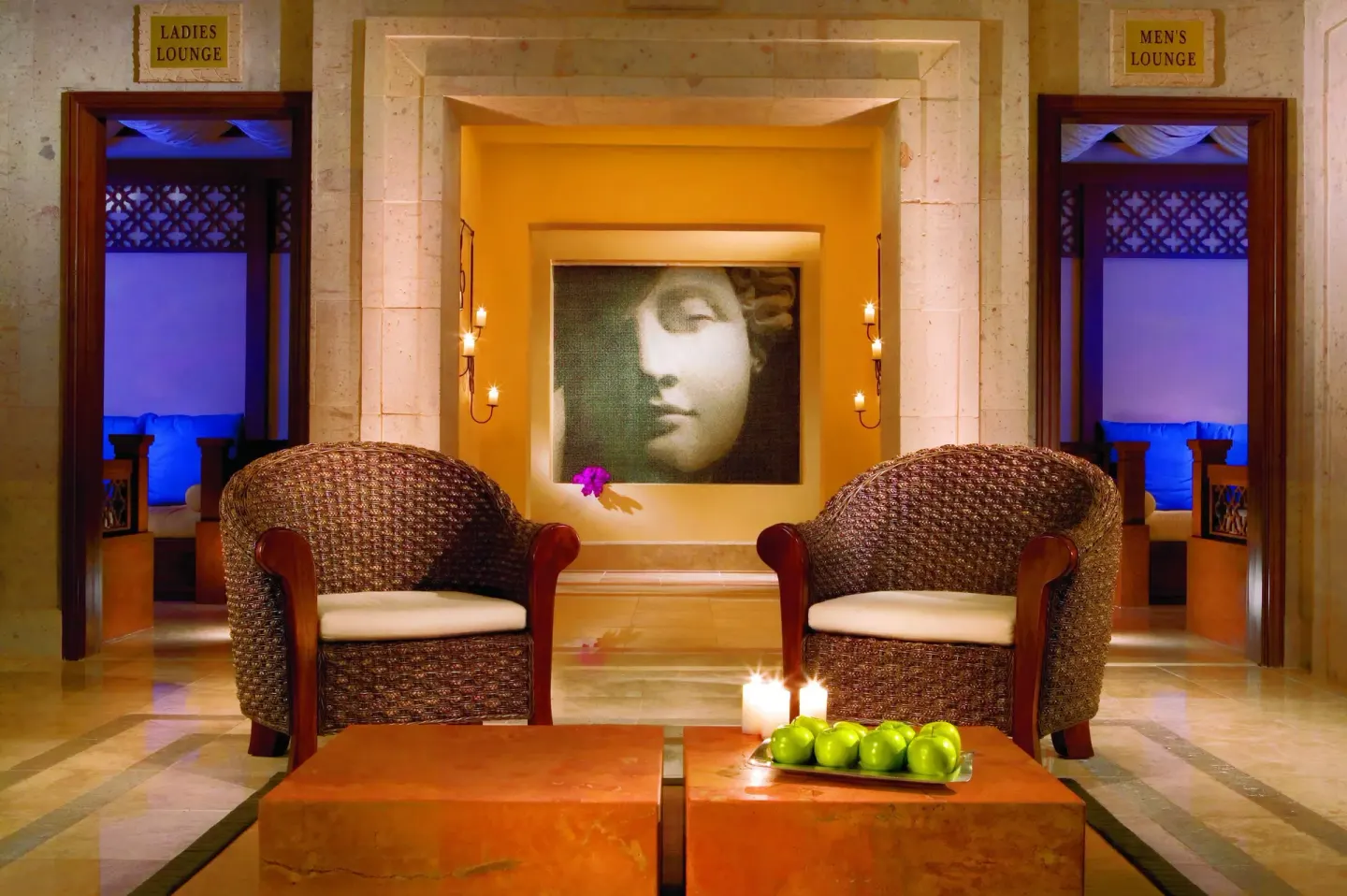 Spa seating area with wicker chairs and lounge entrances at Pueblo Bonito Sunset Beach Golf & Spa Resort.
