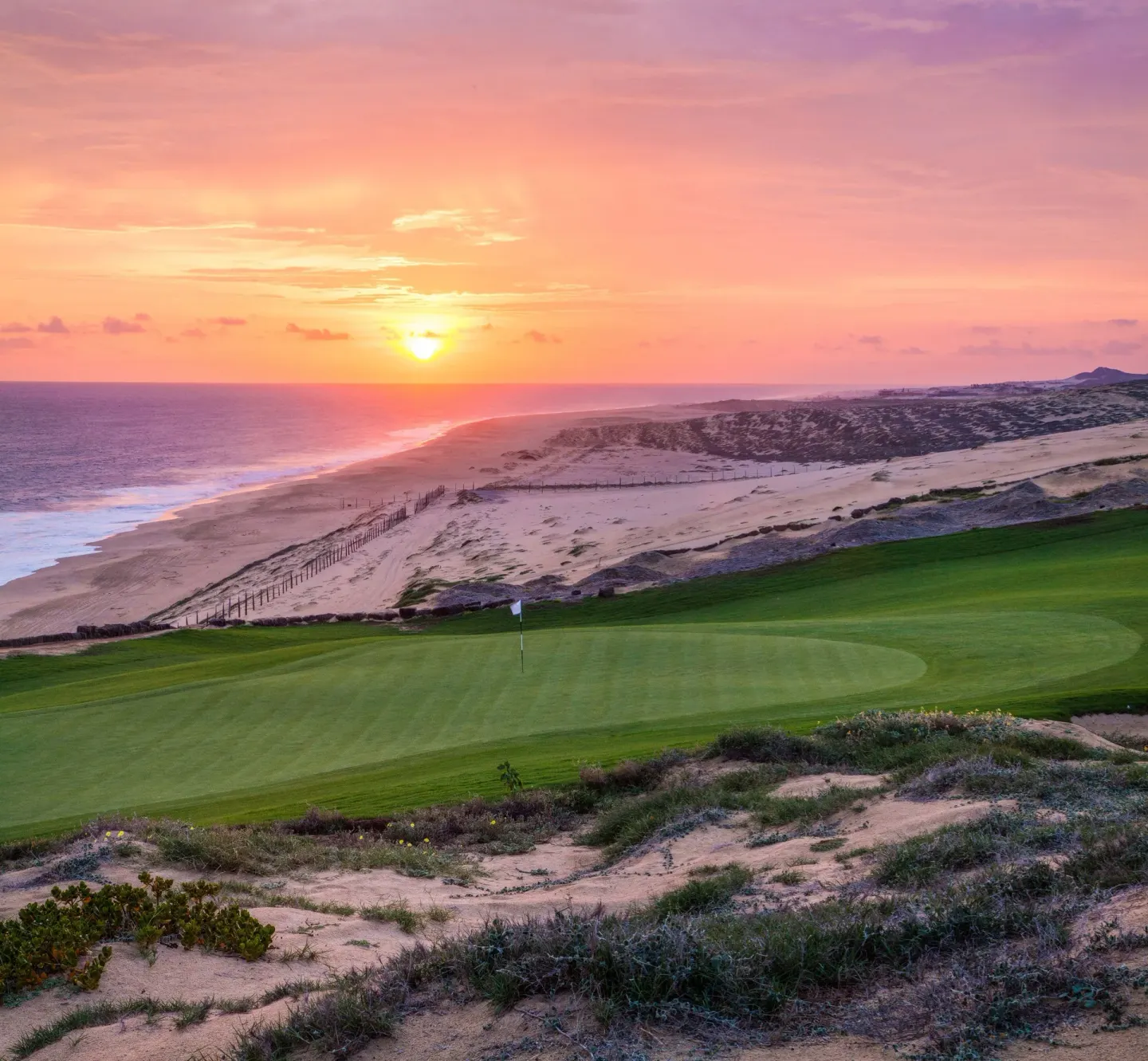 Sunset over a coastal golf green near Pueblo Bonito Sunset Beach Golf & Spa Resort.