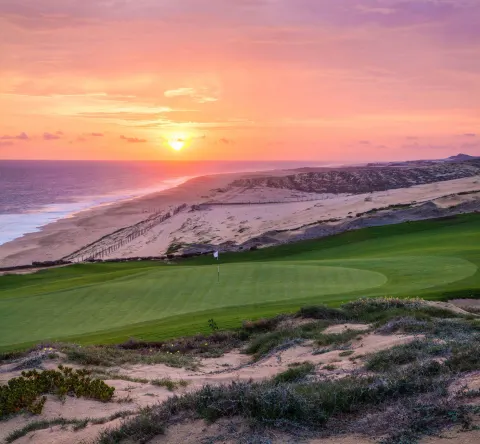 Sunset over a coastal golf green near Pueblo Bonito Sunset Beach Golf & Spa Resort.