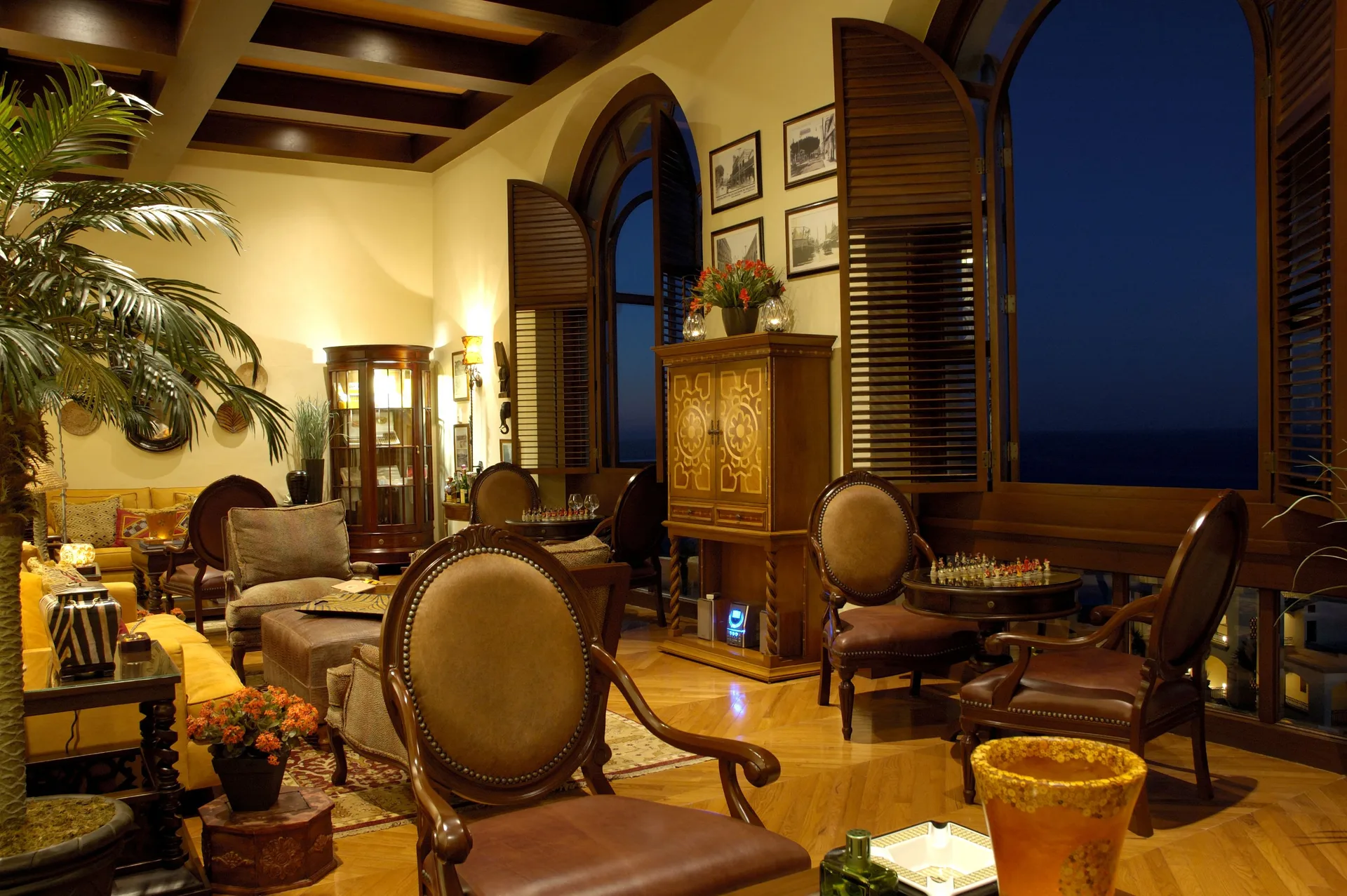 Elegant lounge seating with arched ocean-facing windows at Pueblo Bonito Sunset Beach Golf & Spa Resort.