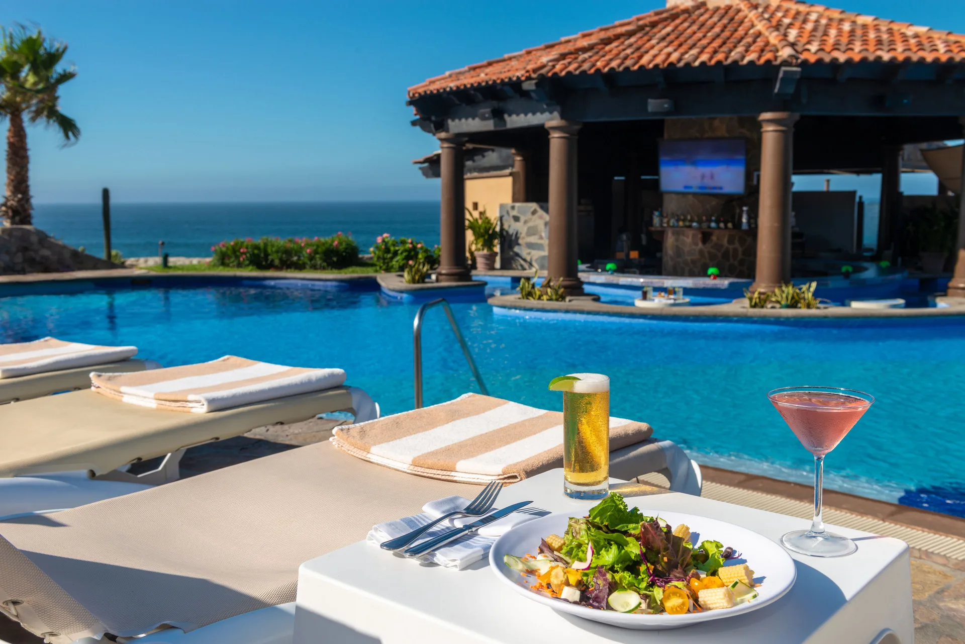 Poolside salad and drinks by the swim-up bar at Pueblo Bonito Sunset Beach Golf & Spa Resort.