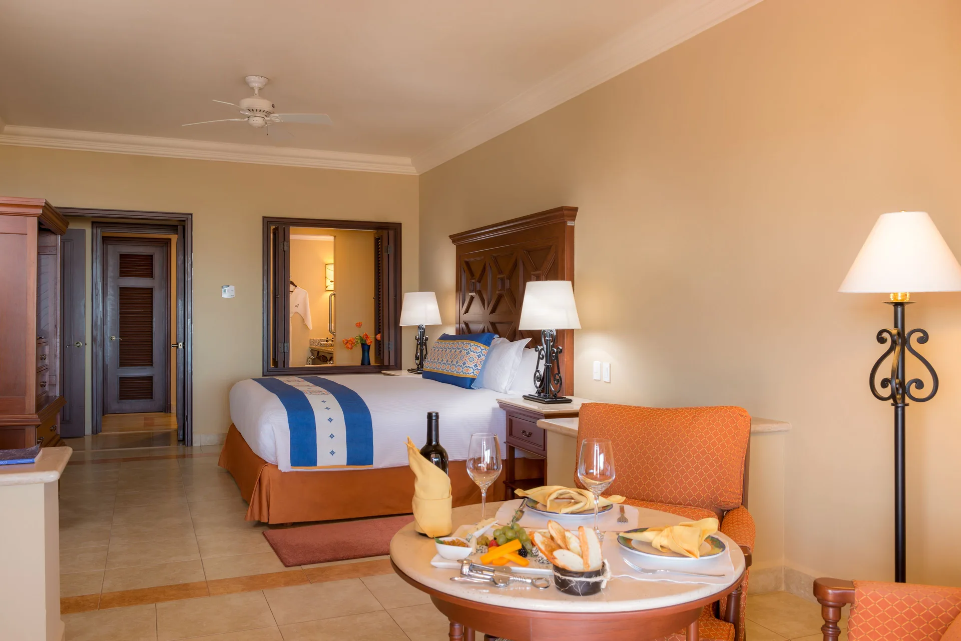 Executive Suite Ocean View bedroom and dining table at Pueblo Bonito Sunset Beach Golf & Spa Resort.