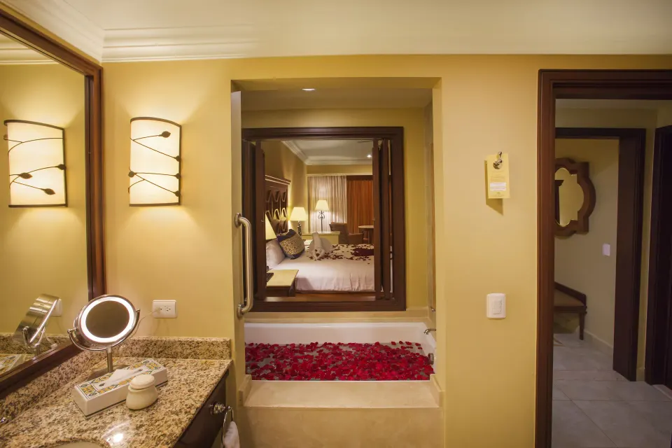 Executive Suite Ocean View bathroom with soaking tub and bedroom beyond at Pueblo Bonito Sunset Beach Golf & Spa Resort.