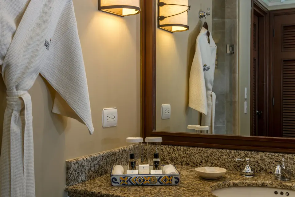 Junior Suite Ocean View bathroom vanity with robe at Pueblo Bonito Sunset Beach Golf & Spa Resort.