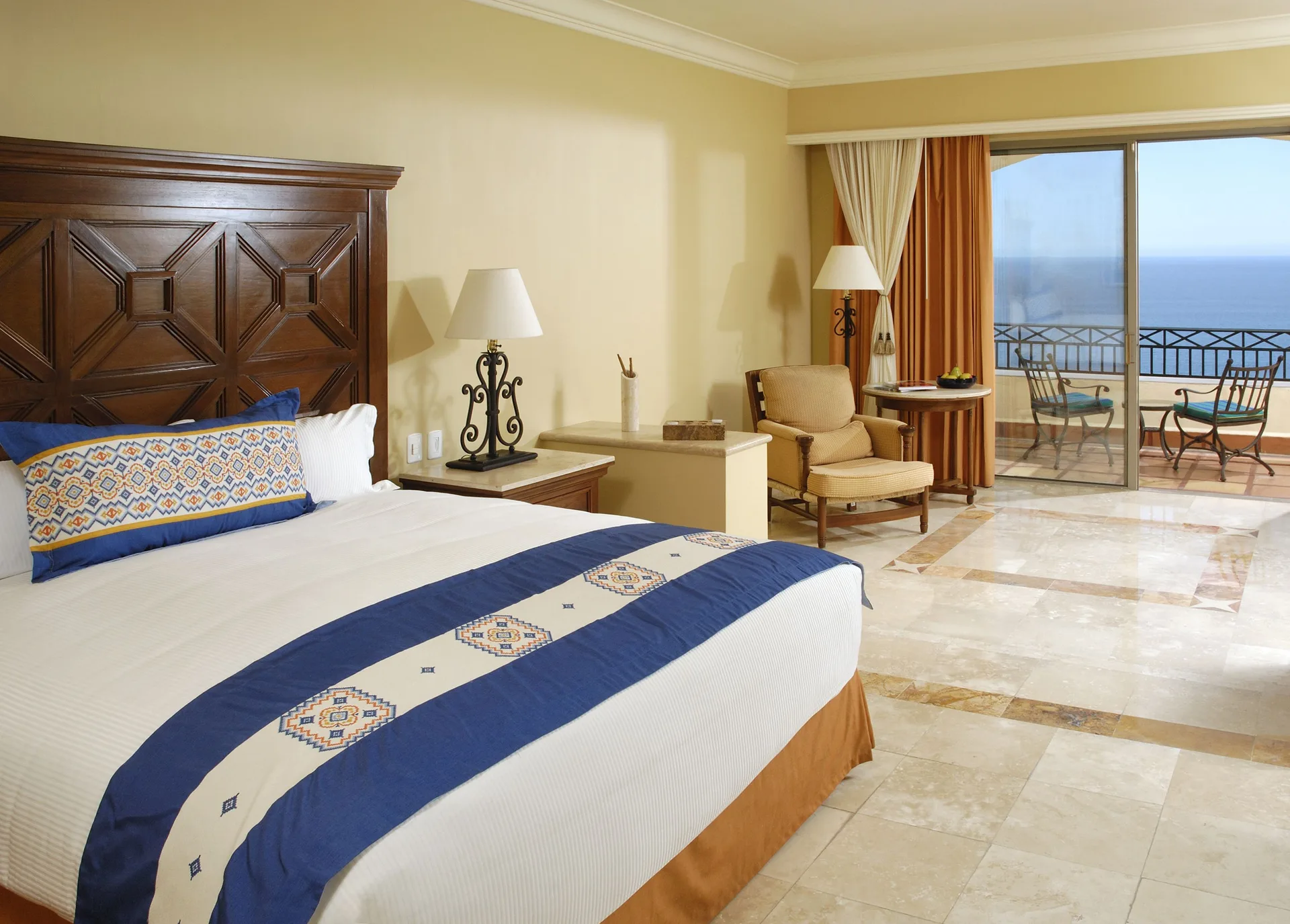 Junior Suite Ocean View king bed and balcony at Pueblo Bonito Sunset Beach Golf & Spa Resort.