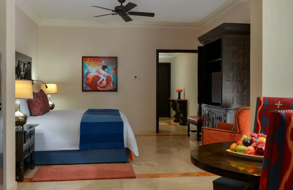 Junior Suite Ocean View king bed and dining table at Pueblo Bonito Sunset Beach Golf & Spa Resort.