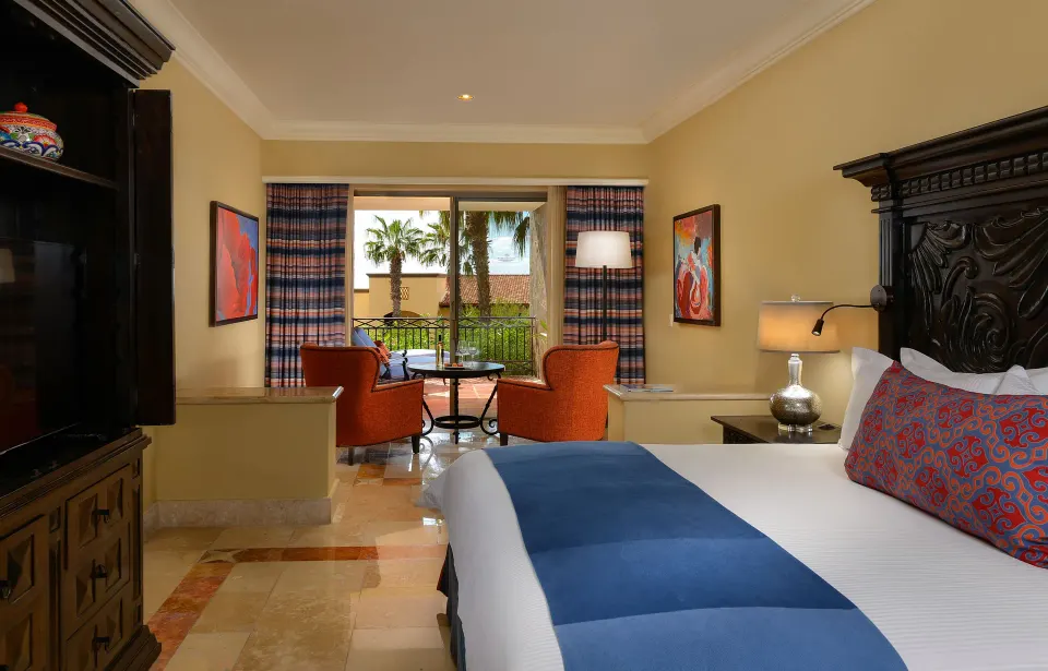 Junior Suite Ocean View king bed with seating area at Pueblo Bonito Sunset Beach Golf & Spa Resort.