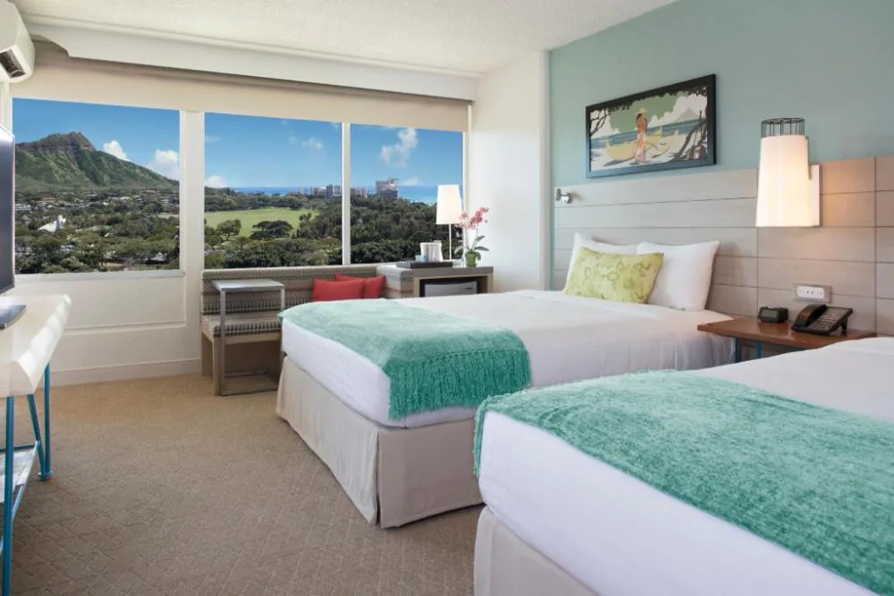 Diamond Head View Balcony room with two beds and mountain views at Queen Kapiolani Hotel.
